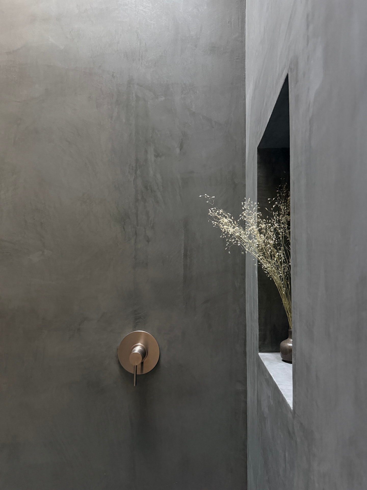 Hand-finished plaster shower with aged brass fittings