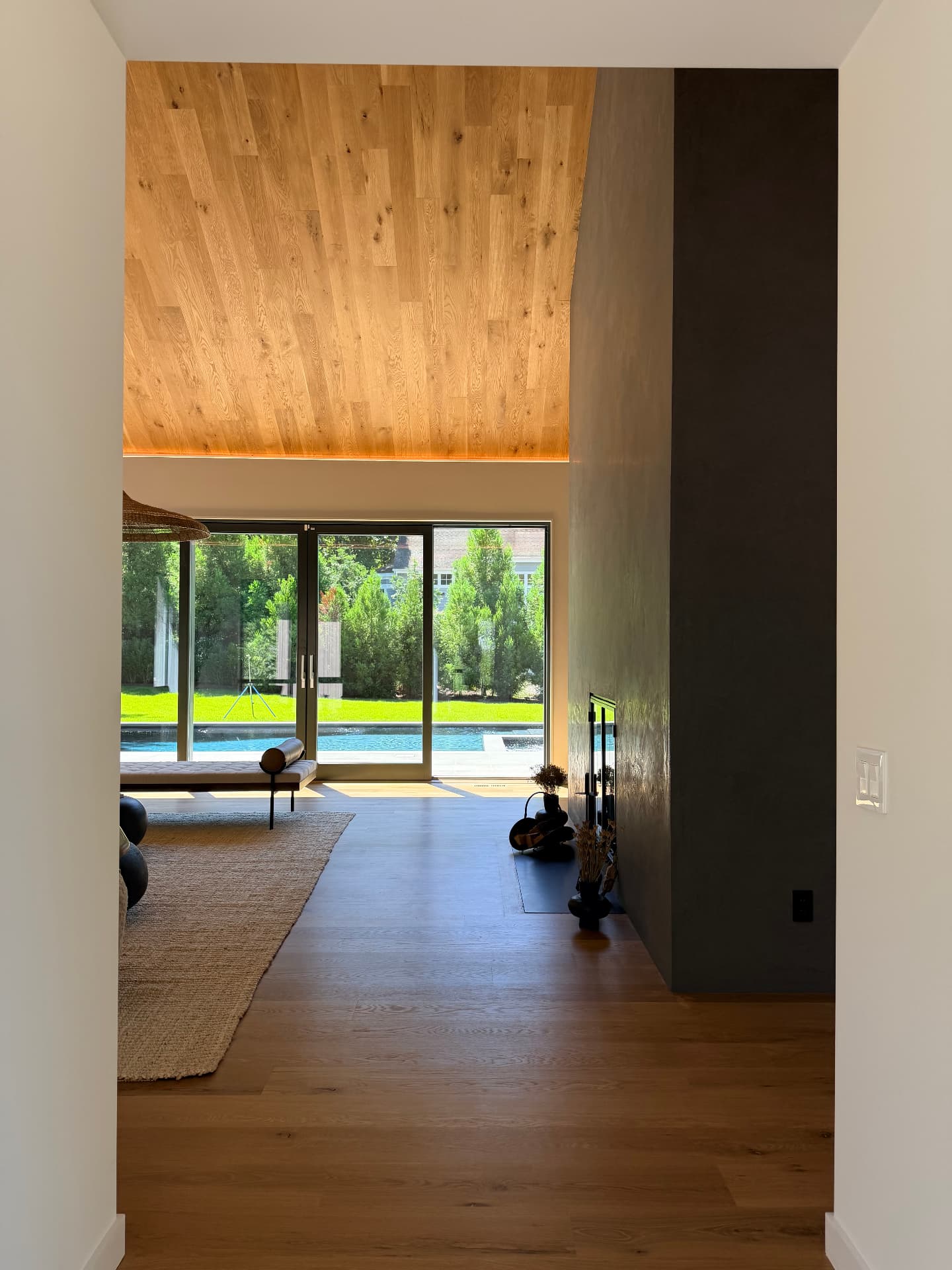 A Juno living room opening directly to the pool and garden
